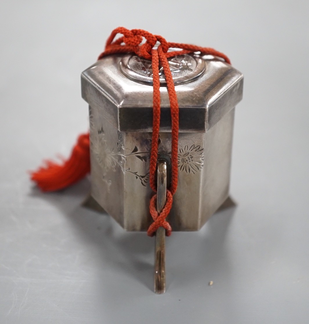 An early 20th century Japanese white metal hexagonal box and cover, signed to the base, height 53mm, gross weight 74 grams.